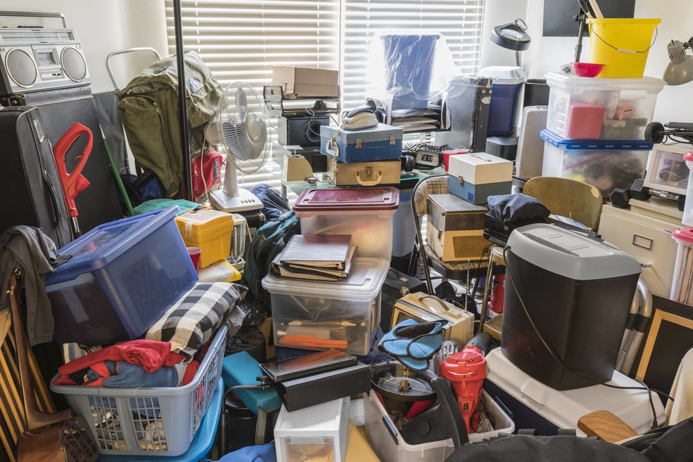 A room in a house almost completely full with household clutter, hoarding may be the cause 